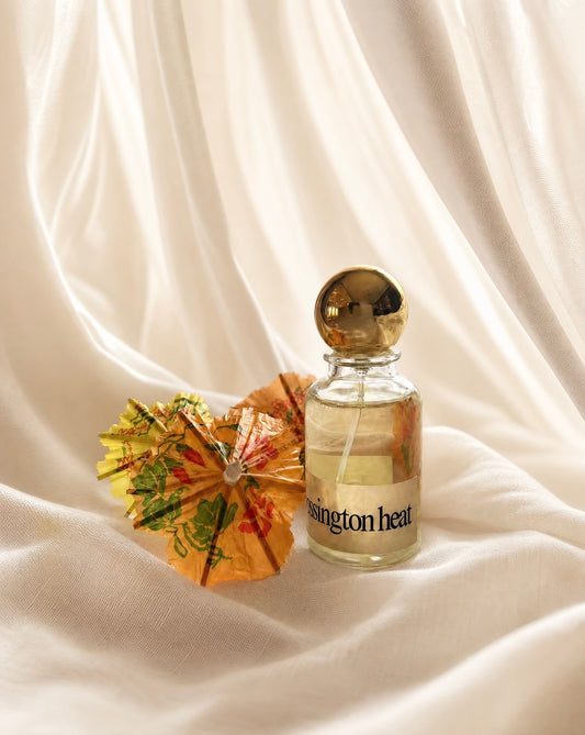 Perfume bottle labeled 'ossington Heat' on a white fabric background